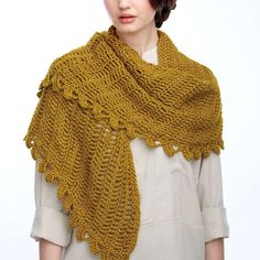 a woman wearing a yellow knitted shawl