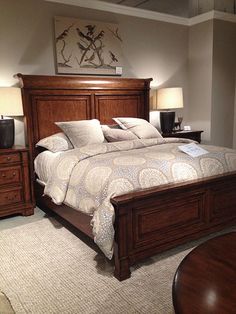 a bedroom with a bed, nightstands and lamps