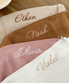 four personalized name knits on a wooden table with plates and utensils