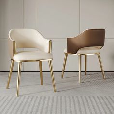 two modern chairs sitting next to each other on carpeted floor in front of wall