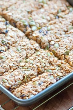 a pan filled with granola bars sitting on top of a wooden table