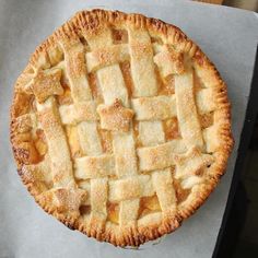 an apple pie sitting on top of a piece of wax paper