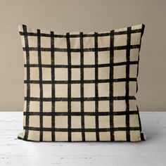 a black and white pillow sitting on top of a table