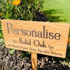 a wooden sign sitting in the middle of a garden