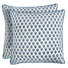 two blue and white pillows with an elephant pattern on the front, one is made out of