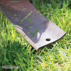 a knife laying in the grass on top of it's side with its blade sticking out