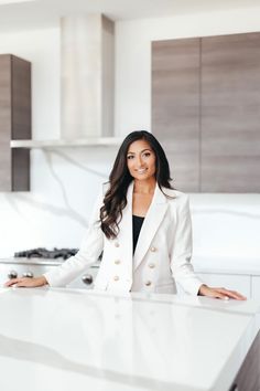 a woman standing in front of a kitchen counter