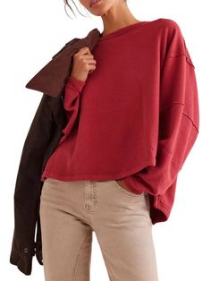 Woman wearing a loose red sweater with beige pants, holding a brown jacket over her shoulder. Winter Inspo, Total Eclipse, Chic Look, Trim Detail, Oversized Tee, Dolman Sleeve, Oversized Fits, Effortless Style, In Style