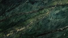 green marble textured with gold veining and black streaks on the top right side