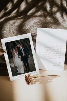 a couple standing next to each other in front of a card with the same photo on it