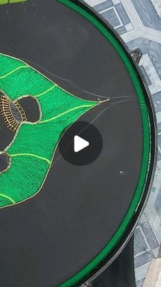 a close up of a green and black table with a drawing on it's surface