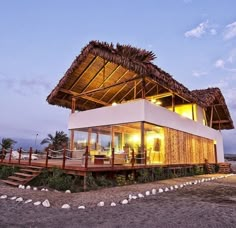 a house with a thatched roof on the beach