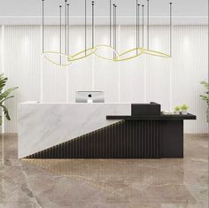 an office lobby with a marble counter top and chandelier hanging from the ceiling