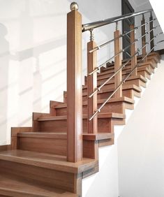 a set of wooden stairs with metal railings