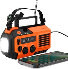 an orange and black radio next to a cell phone