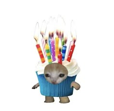 a cupcake with candles sticking out of it's face and an animal in the middle