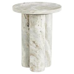 a white marble table with three columns on it's sides and one column in the middle