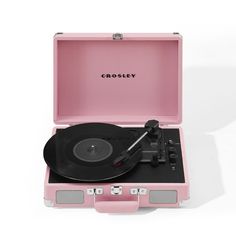 a pink suitcase with a record player in it and the word crosley printed on the lid