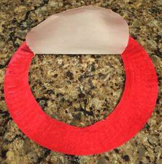 a paper plate with a red circle on it sitting on top of a granite counter