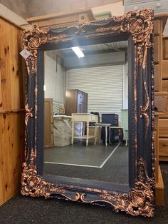 a mirror sitting on top of a floor in a room