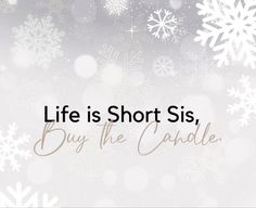 the words life is short, buy the candle are in front of snowflakes