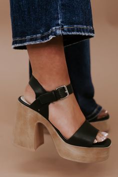 The sandal of the season! The Sadie Chunky Platform Heel truly elevates any look. Featuring an ultra comforting platform style, adjustable buckle strap, and true to size fit. Upper Material: Vegan synthetic upper Insole Material: Padded Insole Sole or Heel Material: Synthetic outsole Heel Height: 4.25" The front platform: 1.5" Types of closures: Slip on/ Buckle True to size ﻿Need help with sizing? No problem! Join our VIP group on Facebook, Everyday Chic Boutique VIP Insiders to chat directly wi Chunky Platform Heels Outfit, Platform Heels Outfit, Boho Heels, Heels Outfits, Black Platform Heels, Vip Group, Everyday Chic, Platform Heels Chunky, Swag Shoes