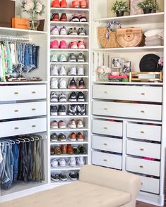 an organized closet with white drawers and lots of shoes on the shelves in front of it