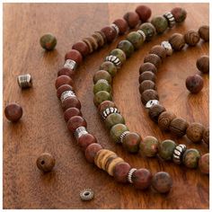 Upgrade your jewelry with these Wood & Stone Bead Strands. These strands feature wooden beads with a busy wood grain finish and stone beads in smooth greens, pinks, and reds. They are separated by stylish metal spacers. Work these beads into a bracelet or wrap them around a stylish necklace! Add new dimensions and depth to your next project with beads for every look. Details: 	 Strand Length: 7" 	 Smallest Bead Dimensions: 1.7mm x 5.7mm 	 Largest Bead Dimensions: 8.2mm x 8.2mm 	 Approximate Hole Wood Bead Jewelry, Wood Beads Jewelry, Beaded Projects, Silver Age, Stylish Necklace, Wood Stone, Metallic Colors, Bead Strand, Clay Beads