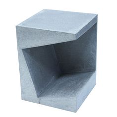 a square concrete block with one section missing from the top and another part missing from the bottom