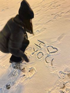 a man is walking in the snow with his feet up and writing on the snow