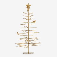 a gold christmas tree with birds sitting on the top and one bird perched on it