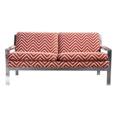 a red and white couch sitting on top of a metal frame