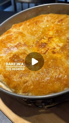 a pan filled with food sitting on top of a wooden table