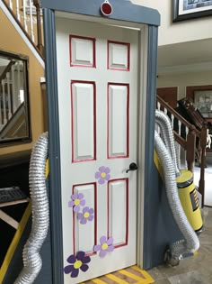 the door is decorated with flowers and hoses