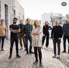 a group of people standing on top of a wooden floor next to eachother