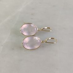 ITEM DESCRIPTION: >> The earrings are made from Solid 14K Yellow Gold. Gemstone used is absolutely natural and ethically sourced. >> Natural Rose Quartz in oval shape and bezel setting is studded on it with utmost precision with Lever back closure. >> This is a minimalist design and is absolutely hassle-free and everyday jewelry.  Gem: Rose Quartz Gem size: 13x18 mm  Gem weight: 26.65 carats Gold purity: 14K (58.33% approx.) Gold weight: 1.33 grams  Gross weight: 6.66 grams The Gold purity is guaranteed and it comes with authentic 14K gold hallmark. Since these Earrings are handmade, they are Nickel/Lead FREE.  CUSTOMIZATION: --> Pendant of the same design is also available on my Etsy Shop. --> You can choose your own gemstone. --> Kindly drop a message for more options. CUSTOMER SUPPORT: Elegant Faceted Hoop Earrings As Gift, Elegant Pink Gold Hoop Earrings As Gift, Elegant Pink Gold Hoop Earrings For Gift, Modern 14k Gold Pink Jewelry, 14k Gold Faceted Earrings For Anniversary, Elegant Pink Gold Jewelry With Ear Wire, Elegant Oval Hoop Earrings With Gemstone, Fine Jewelry 14k Pink Gold Earrings, Pink Gold Gemstone Earrings In Fine Jewelry Style