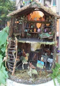 an image of a doll house made out of tree stumps and other things on display