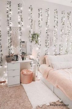 a bedroom decorated with white lights and pink bedding