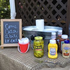 some condiments are sitting on a table outside