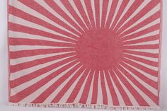 a red and white square rug with fringes on the bottom in front of a white background