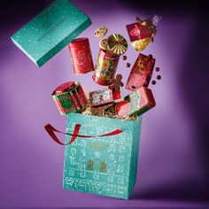 a green bag filled with candy and candies on top of a purple tablecloth