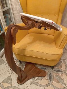 a wooden rocking chair with a surfboard on it's back and arms in the shape of a cat