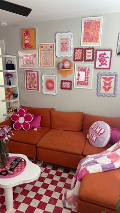 a living room filled with furniture and pictures on the wall