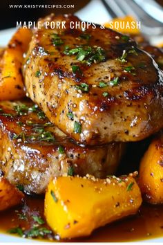 some meat and potatoes on a plate with a fork in the background that says maple pork chops & squash