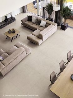 an aerial view of a living room with couches and tables