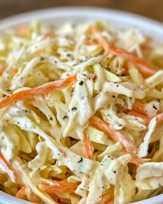 a white bowl filled with coleslaw and carrots