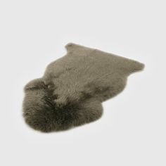 an animal fur rug is shown on a white background, with the top part of it's tail visible