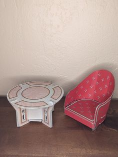 two chairs and a table on a wooden floor