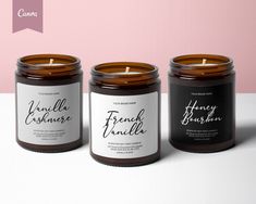 three candles sitting next to each other on top of a white table with pink background