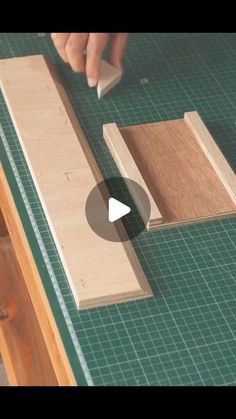 a person is using a piece of wood to make a cabinet